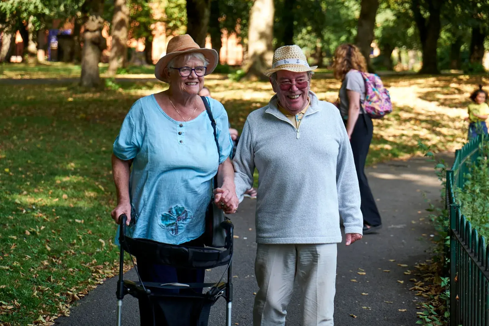 Senior couple walking together in a sunny park