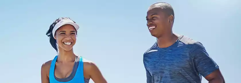 Smiling Couple Exercising Outdoors