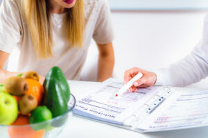 a nutrition specialist with a patient discussing nutrition