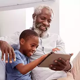 Grandfather and Grandson Using a Tablet Together